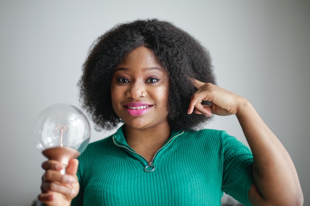 positive-young-african-american-lady-holding-light-bulb
